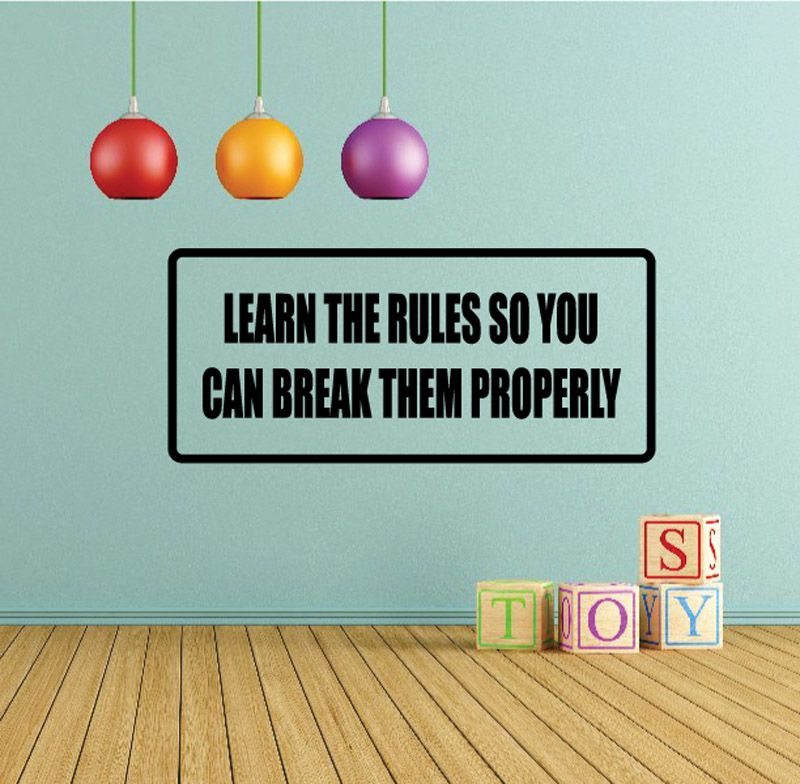 Rectangular wall decal with black border, reads: LEARN THE RULES SO YOU CAN BREAK THEM PROPERLY