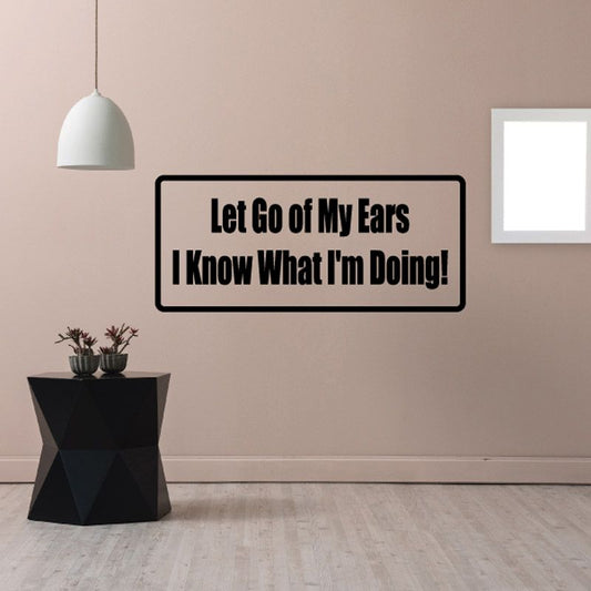 Black-outlined wall decal reading 'Let Go of My Ears, I Know What I'm Doing!'