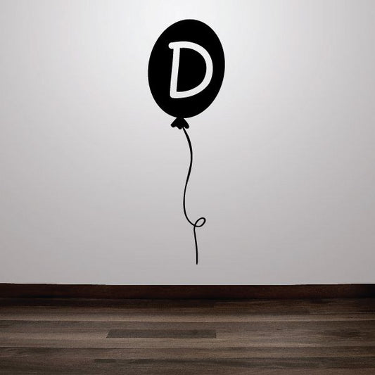 Black balloon decal shaped with white letter D and attached string