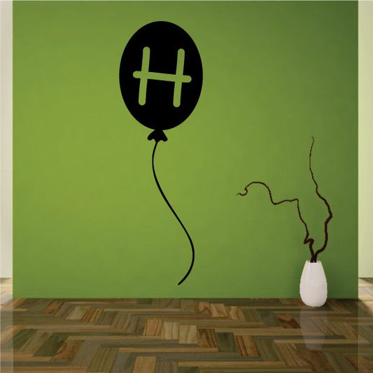 Letter H black balloon decal with green H and balloon string lines