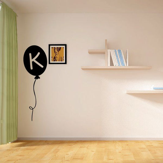 Letter K balloon decal: black round balloon with cream K letter and curly string