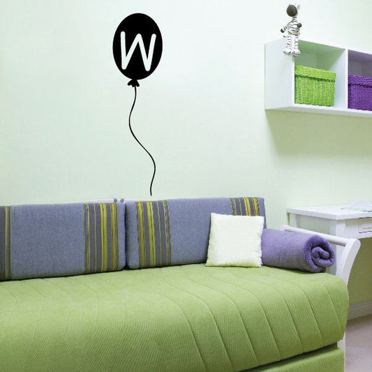 Black balloon decal with white letter W