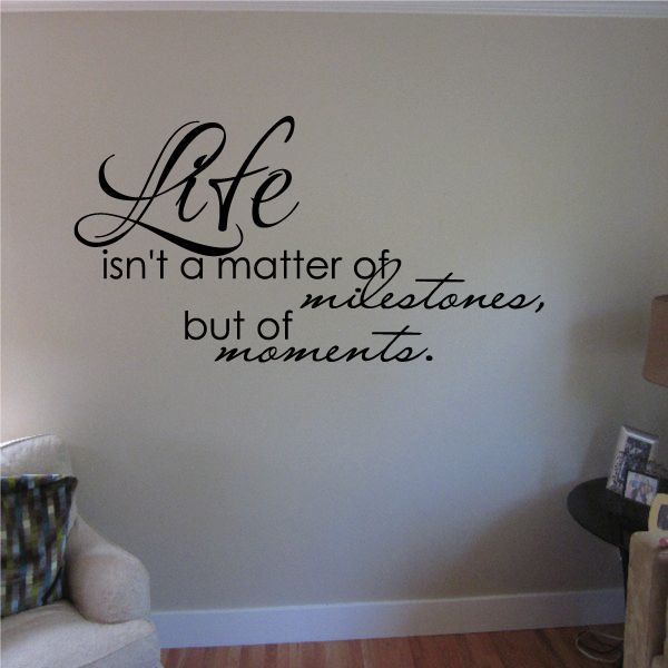Wall quote decal with cursive 'Life' and 'isn't a matter of milestones, but moments'.