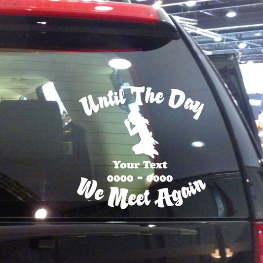 Car window decal: white "Until The Day" text, angel silhouette, "We Meet Again".