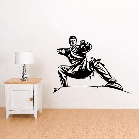 Low stance karate wall decal of a black martial artist in a kneeling pose