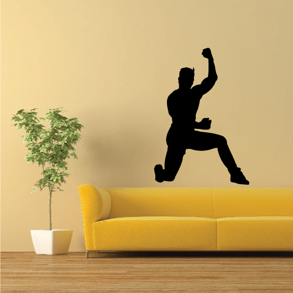 Black male stretching wall decal silhouette, kneeling with one arm raised.