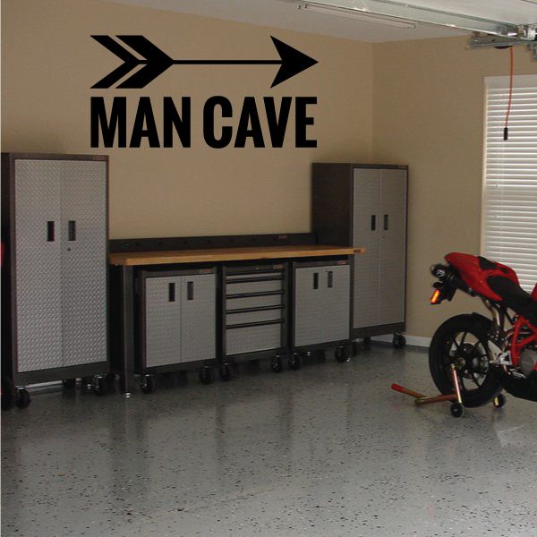 Wall decal with 'MAN CAVE' lettering and two bold arrows