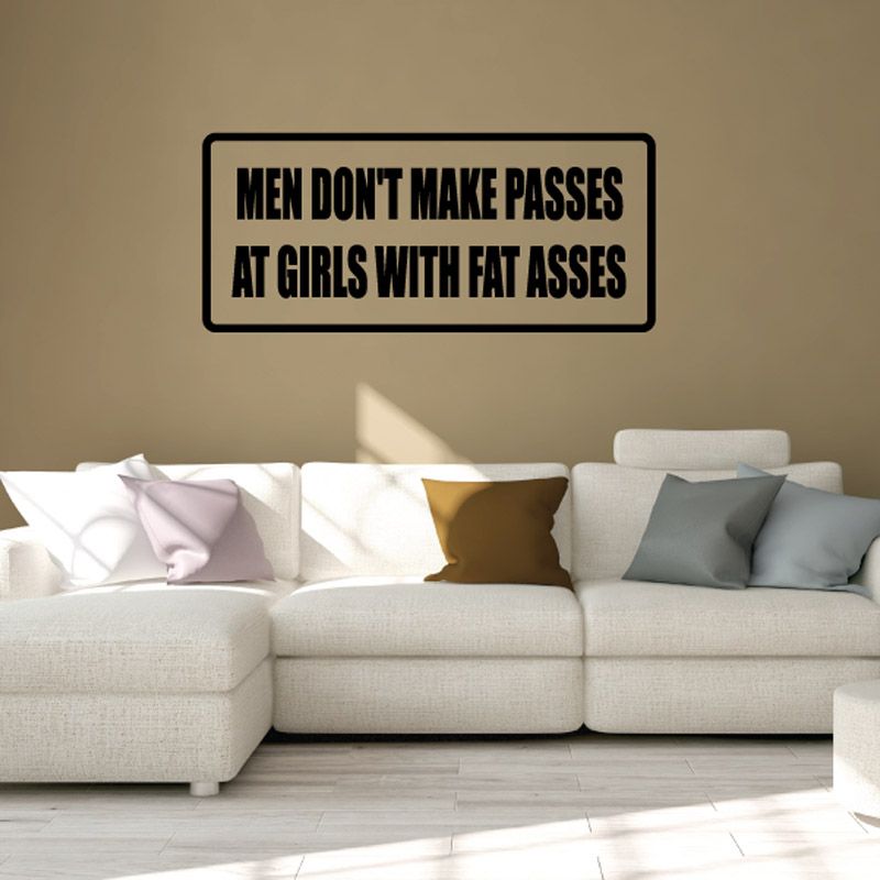 Wall decal with black border reading “MEN DON'T MAKE PASSES AT GIRLS WITH FAT ASSES”