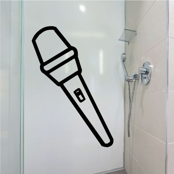 Decorative microphone-shaped decal affixed to a bathroom wall