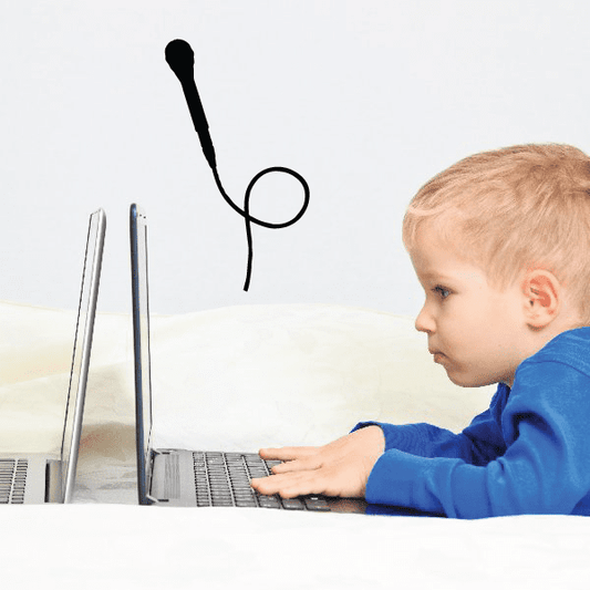 Child's bedroom with a microphone wall sticker above the bed and laptops on it