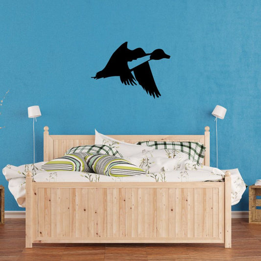 Black flying duck wall decal with wings spread