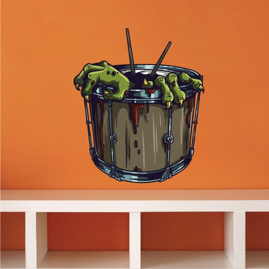 Die-cut monster drum decal with green face and dripping paint over blue drums