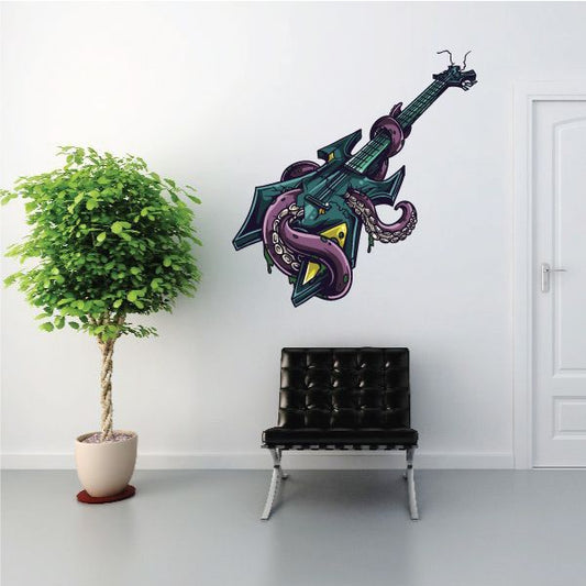 Die-cut decal of a monster guitar with purple body, green strings, and yellow accents