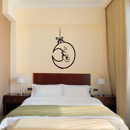 Moon on a string wall decal with cartoon face and hanging bow