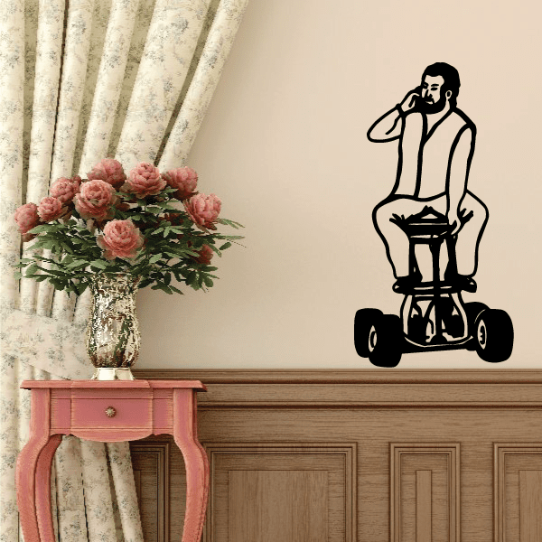 Black motorcycle wall decal of a rider holding a helmet, vinyl sticker