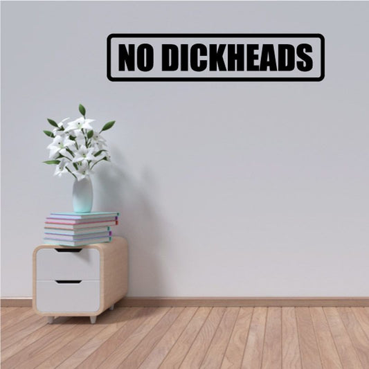 Wall decal with bold black “NO DICKHEADS” text in rounded rectangular border