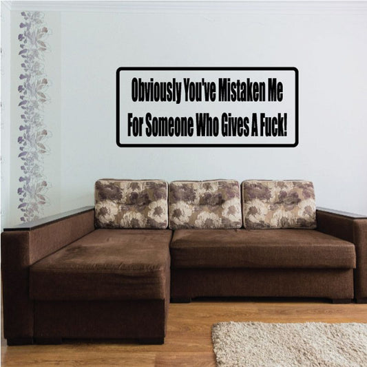 Black bordered wall decal with bold text reading “Obviously You’ve Mistaken Me”