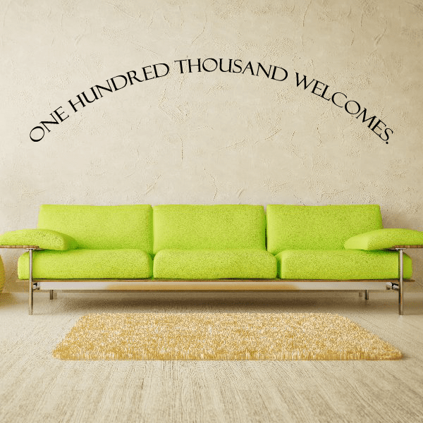 Wall decal with arched black text: ONE HUNDRED THOUSAND WELCOMES!
