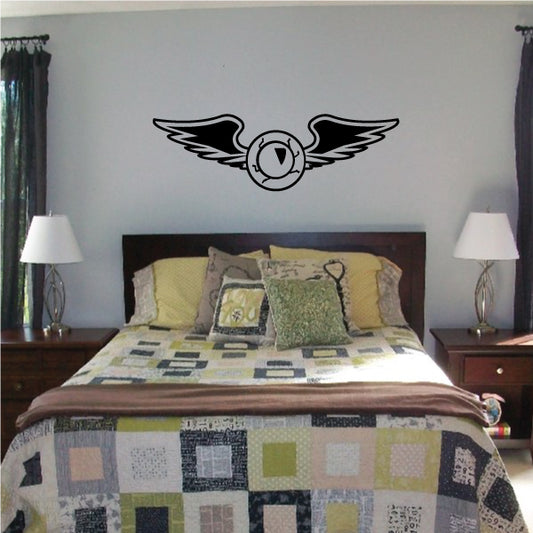 Black wing wall decal with central round emblem