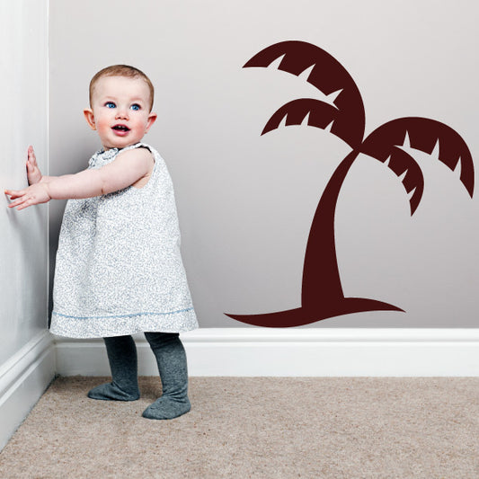 Little girl posing in front of a palm tree wall sticker