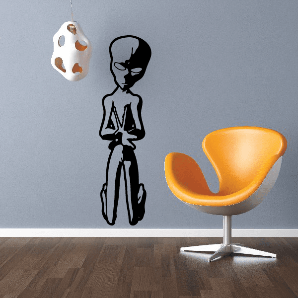 Sticker of an alien wearing a hat and sitting on a chair for wall decor