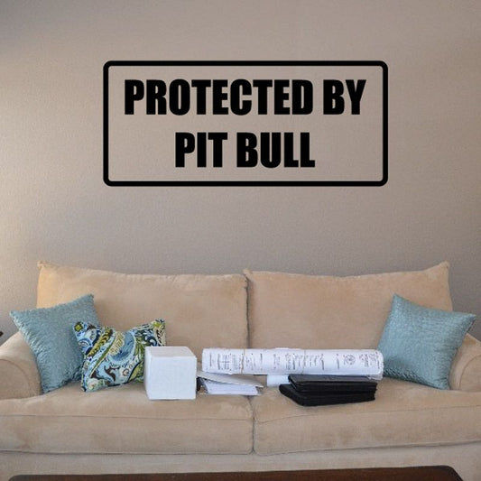 Protected by Pit Bull decal with bold black text on light background, rectangular border