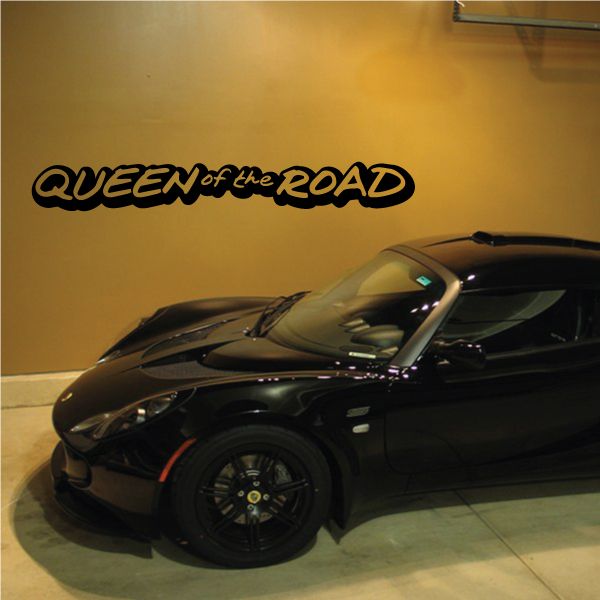 Queen of the Road decal with bold black lettering on a smooth wall surface