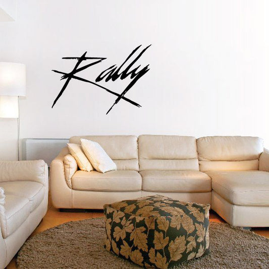 Rally script decal in black on light wall