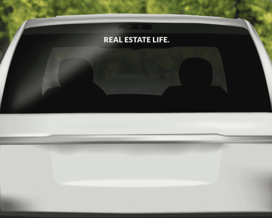 Rear windshield decal at top with REAL ESTATE LIFE and two silhouette figures