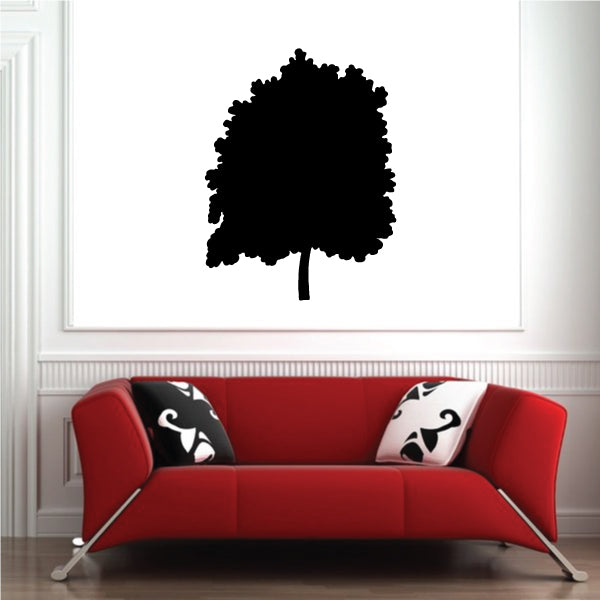 Black tree wall decal with rounded canopy silhouette above red sofa