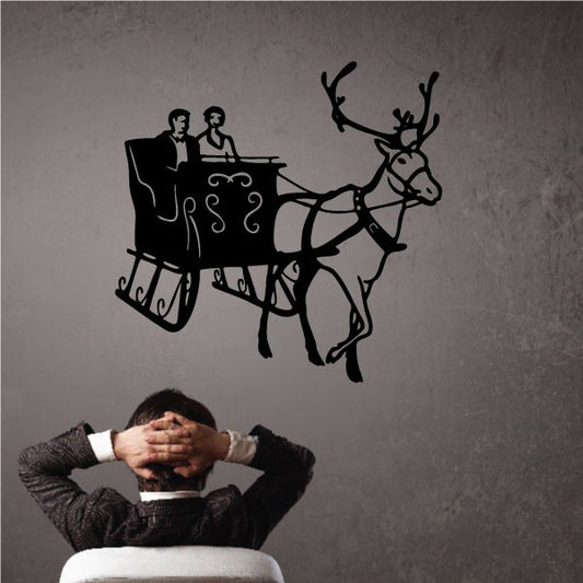 Reindeer pulling sleigh with couple wall decal in black silhouette