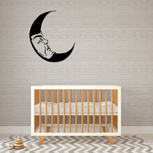 Resting moon decal with a sleeping face inside a black crescent moon