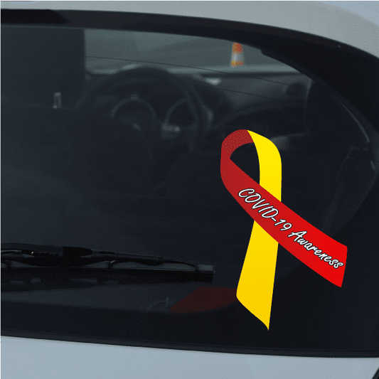 COVID-19 awareness ribbon with red and yellow colors, hanging on a windshield
