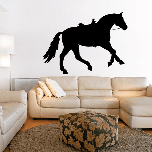 Black saddled horse canter decal silhouette, horse mid-stride with raised tail