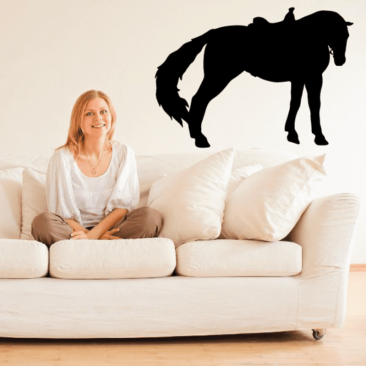 Black stretching horse wall decal, black silhouette of horse with raised leg.
