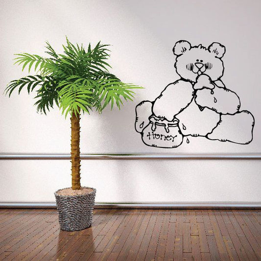 Vinyl decal sticker of cartoon bear holding a honey pot, black outline on white