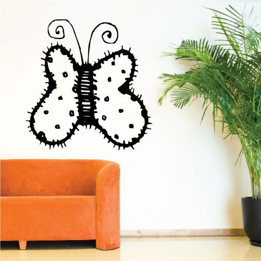 Black vinyl decal of two curled, spotted animal faces with swirled ears