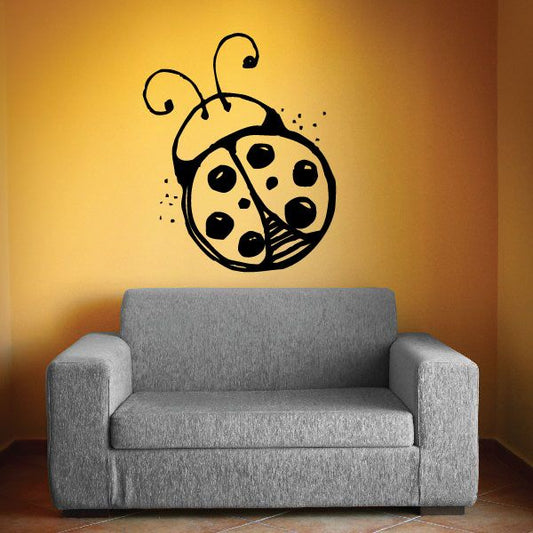 Ladybug vinyl wall decal with curled antennae and spot pattern