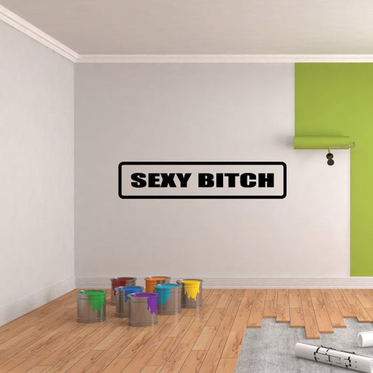 Wall decal reading “SEXY BITCH” in bold black uppercase inside a white badge