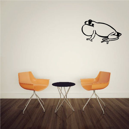 Frog decal showing a side-view white and black cartoon frog with open mouth.