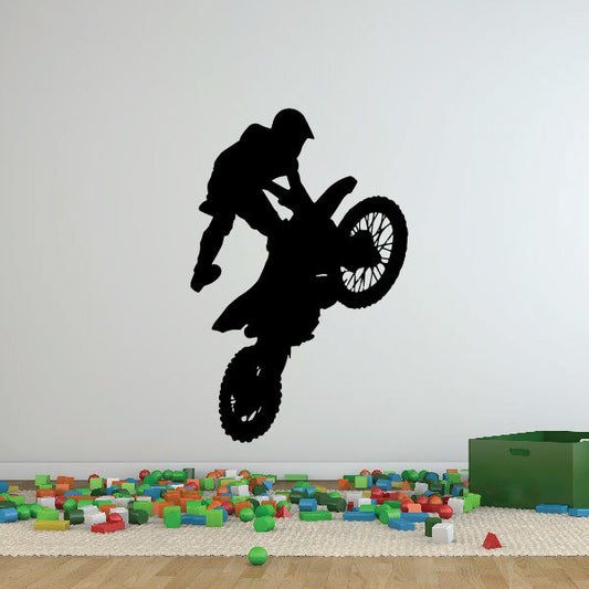 Dirt bike decal with rider silhouette jumping over bike wheels