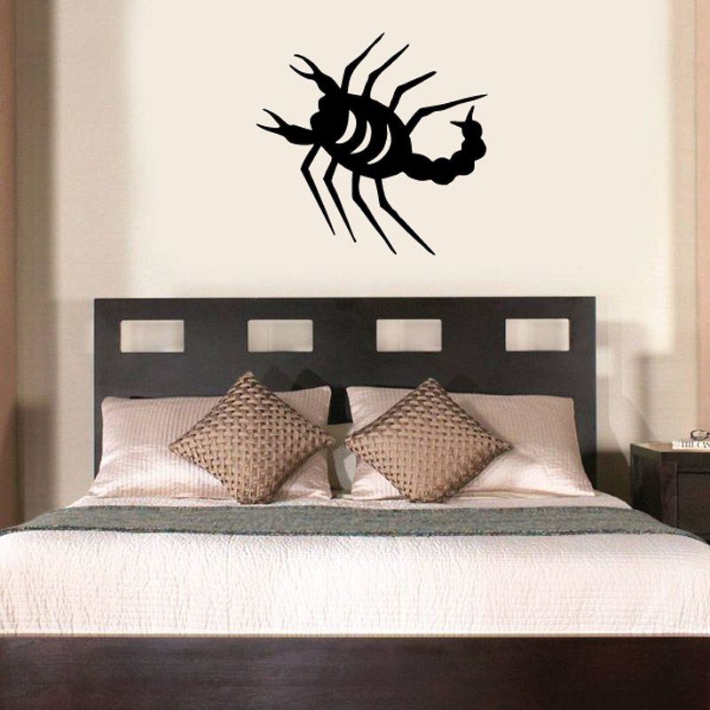 Black simplified scorpion crawling wall decal on a wall
