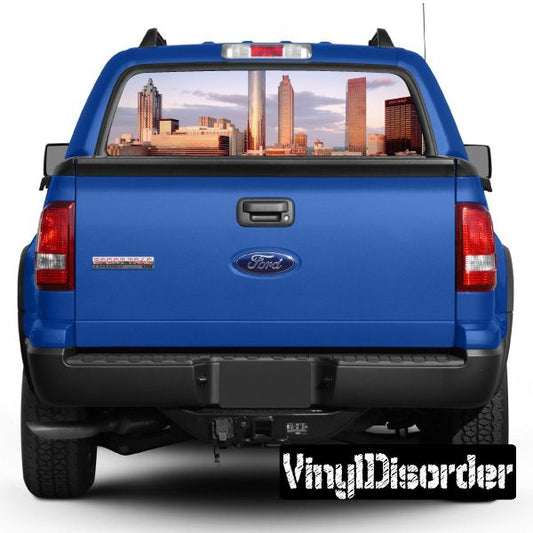Truck rear window graphic with skyline city view and central emblem