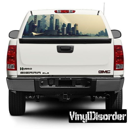 White SUV rear window with Skyline Shanghai city graphic; GMC and Hybrid badges