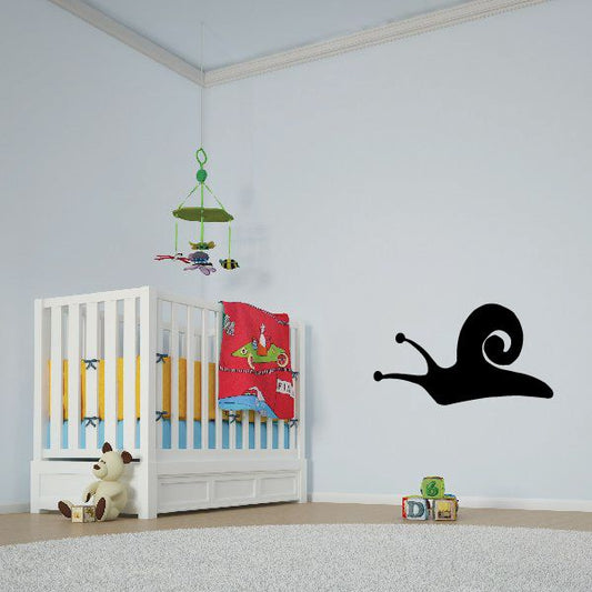 Black snail sliding wall decal with curled shell and antennae