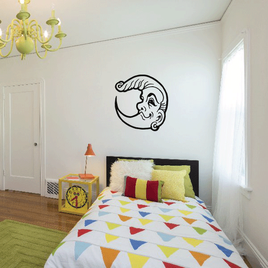 Moon face decal with smiling profile, black outline on wall