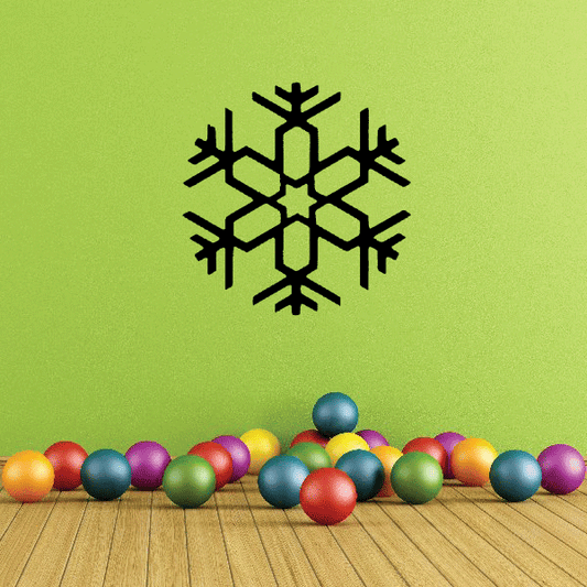 Black snowflake wall decal with a detailed six-armed cut-out star pattern.