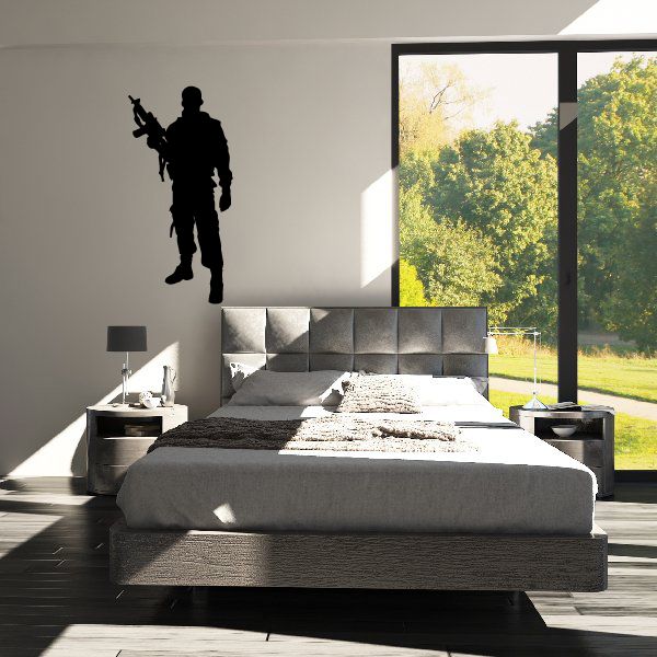 Soldier with AK47 decal: black silhouette holding rifle on a wall.