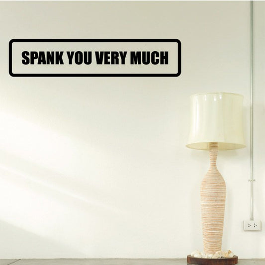 Wall decal with bold black text reading "SPANK YOU VERY MUCH"