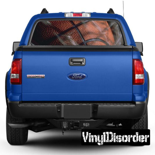 Blue pickup truck with basketball graphic on rear window and rear view emblem